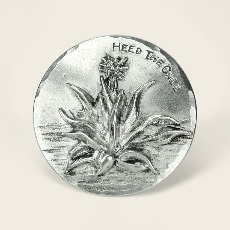 Round sterling silver agave buckle by Cityboy Forge, featuring a detailed agave plant and flower with “HEED THE CALL” engraved above the design—a perfect collaboration with Howler Brothers. - View 1