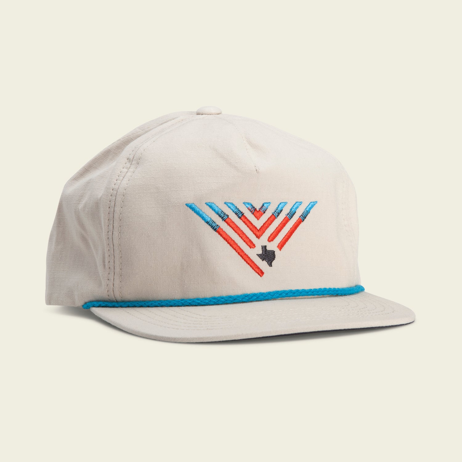 A light beige baseball cap featuring a colorful geometric “V” design and a small black Texas outline. This unstructured snapback has a blue braid above the brim and an adjustable snap back closure for the perfect fit—great for fans of fishing hats.